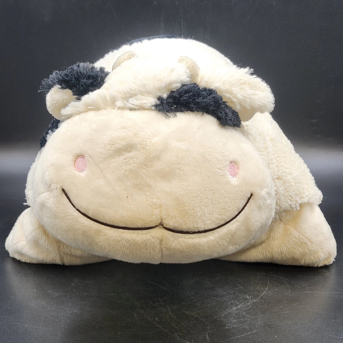 Cream and black spotted Pillow Pets cow plush stuffed animal