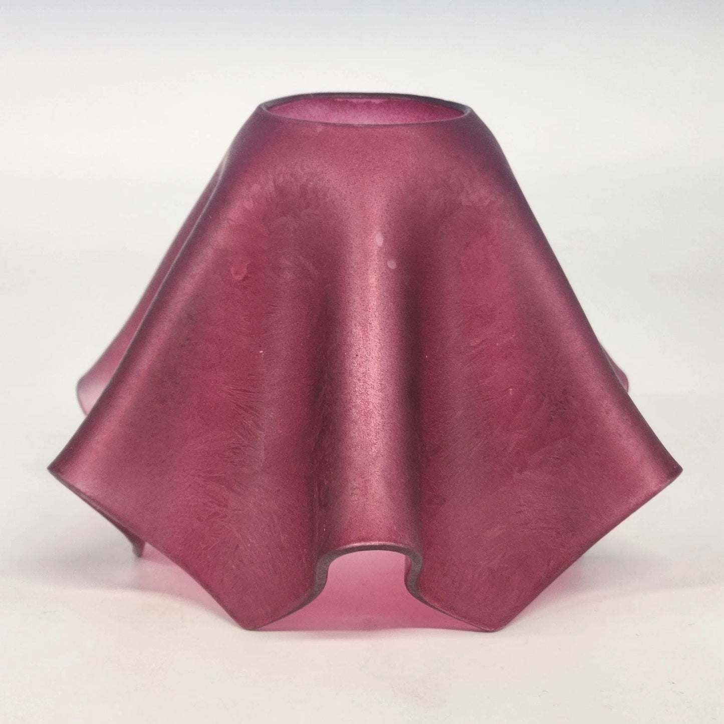 Pink glass shade on a white background