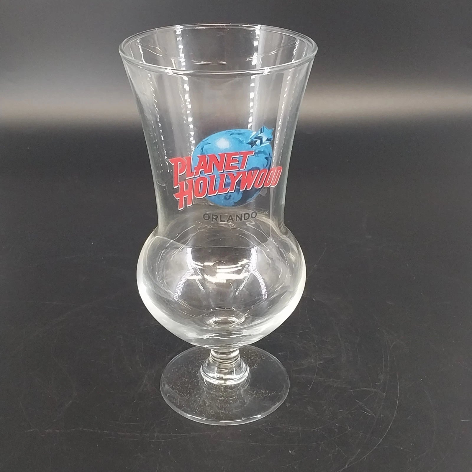 Planet Hollywood Orlando 16 oz hurricane glass with red and blue logo