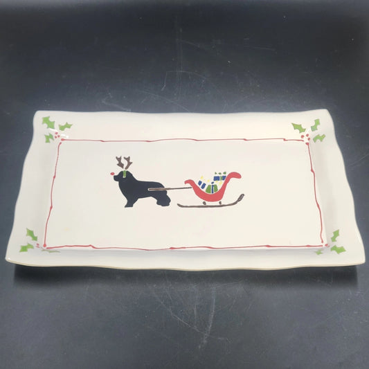 Vintage ceramic platter with black dog pulling a red and green Christmas sled