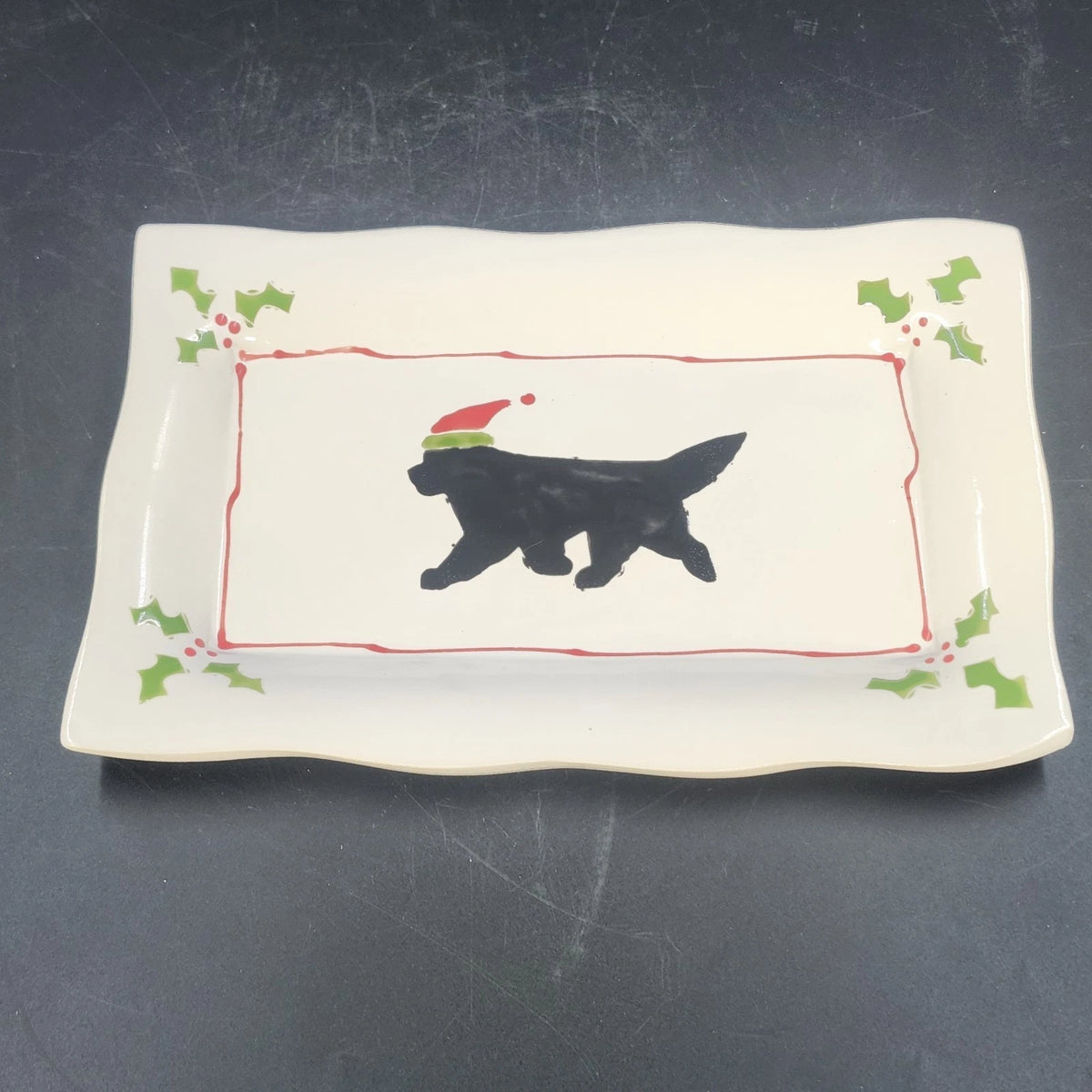 White ceramic rectangular Christmas plate with black dog and Santa hat