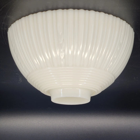 White ribbed ceiling light fixture on a dark background