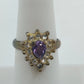 Vintage style gold tone adjustable ring with purple teardrop stone and rhinestones