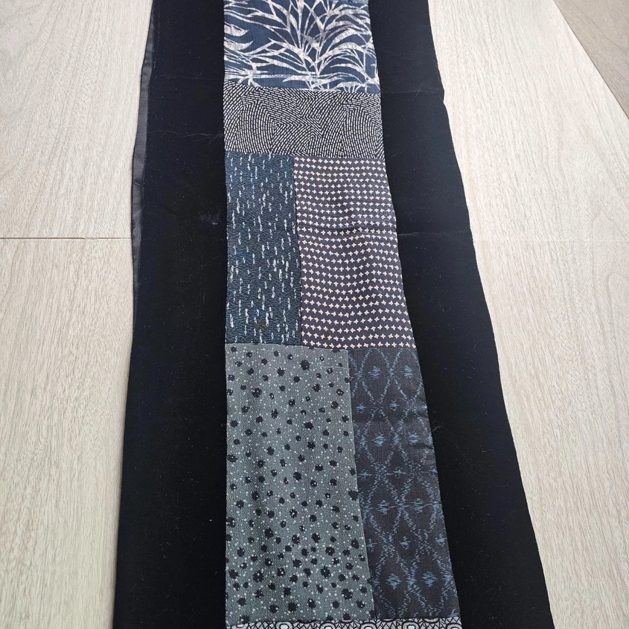 Reversible blue and black patchwork table runner with velvet backing