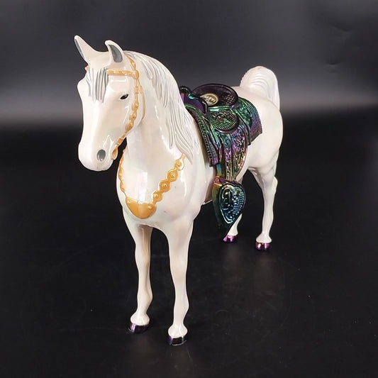 Vintage circus horse toy with iridescent saddle