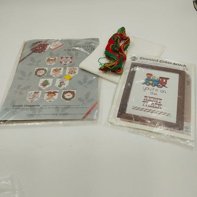 Two counted cross stitch kits with Christmas ornaments and right track design