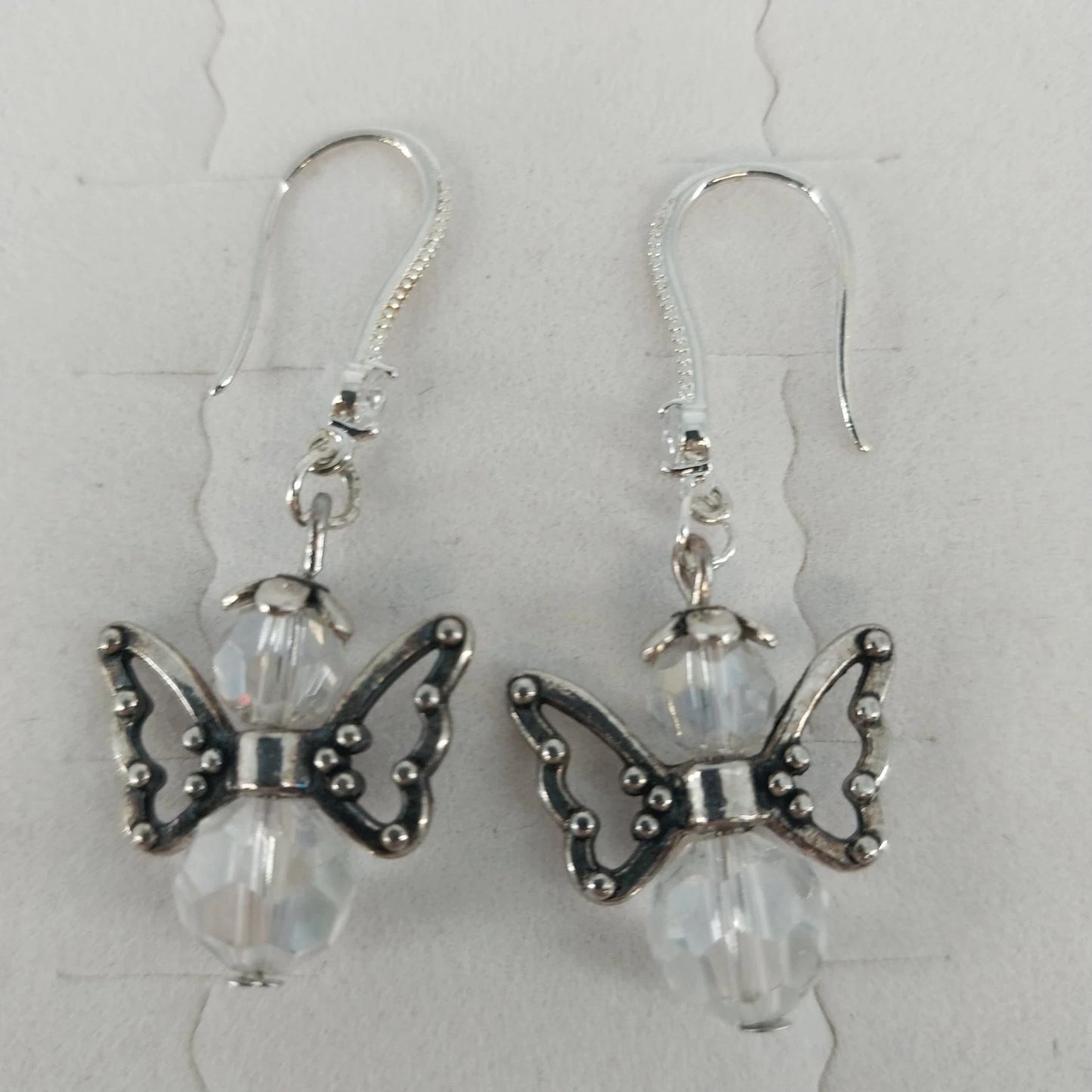 Silver tone angel wing dangle earrings with clear faceted beads