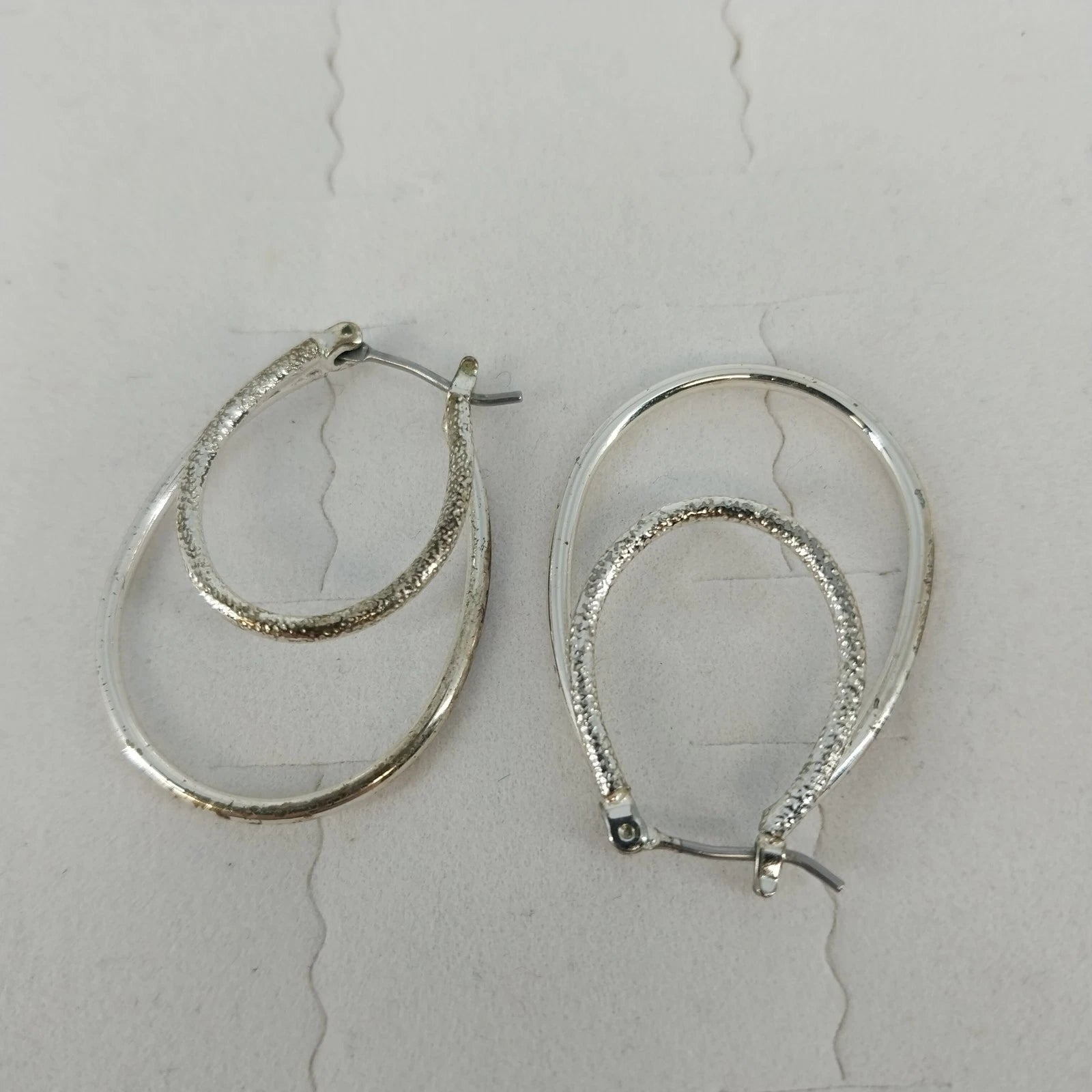 Silver tone double oval hoop dangle earrings