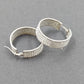 Silver tone wide pave hoop earrings with white rhinestones