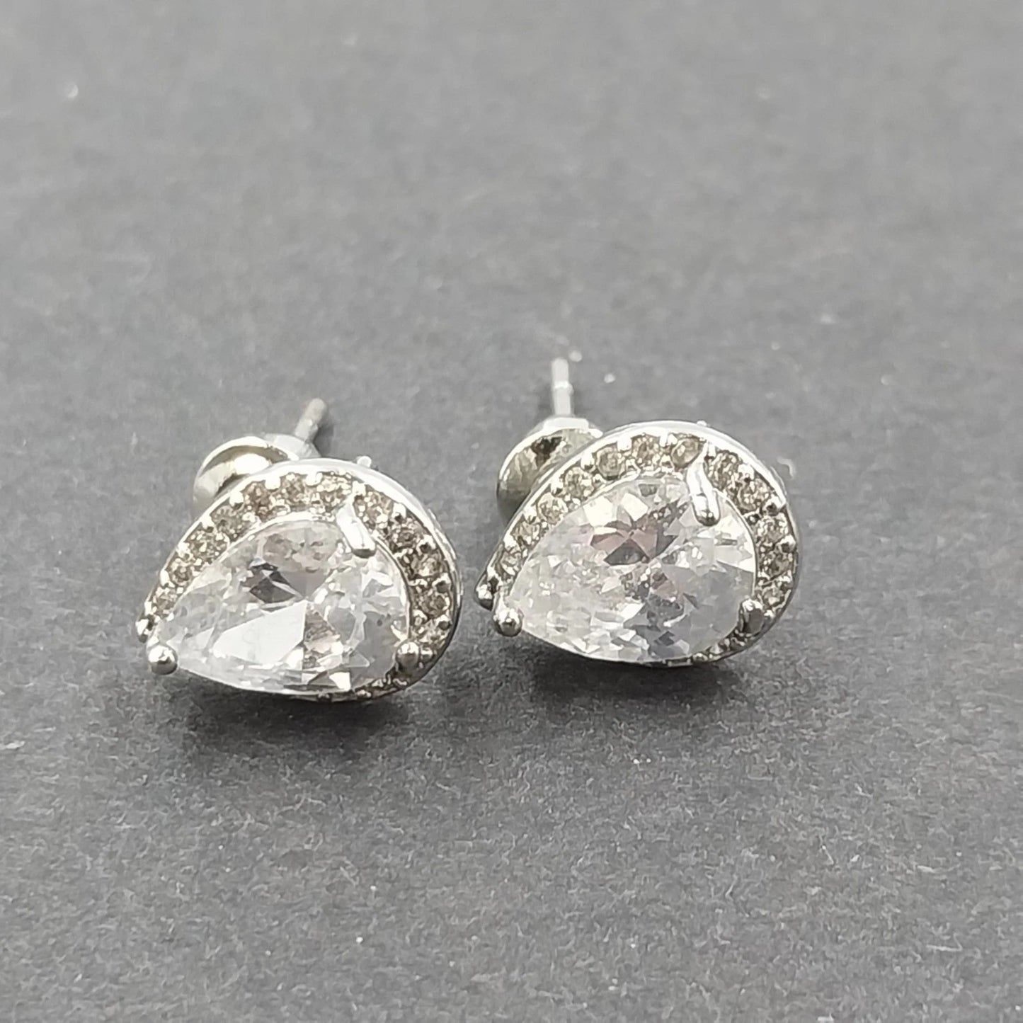 Silver tone pear cut halo stud earrings with clear rhinestones