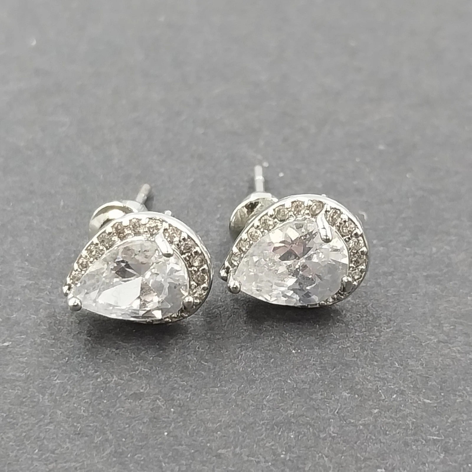 Silver tone pear cut halo stud earrings with clear rhinestones