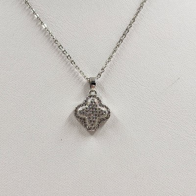 Silver tone cable chain necklace with pave rhinestone clover pendant
