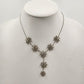 Silver tone necklace with rhinestone starburst flower pendant