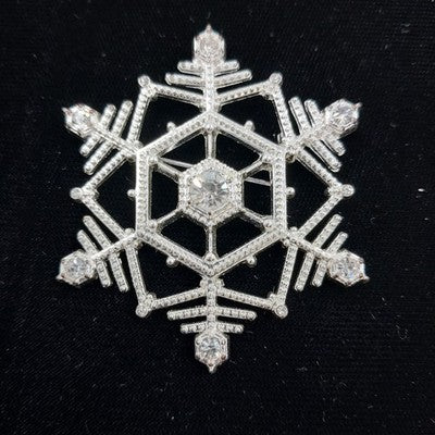 Silver tone snowflake brooch with clear faceted rhinestones