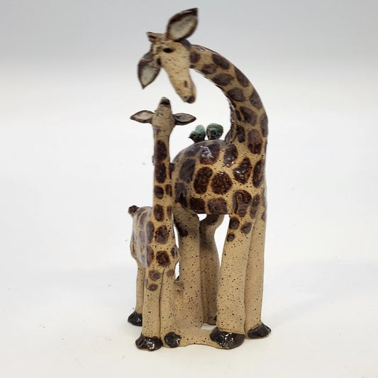 Handcrafted ceramic giraffe family figurine with three giraffes, brown speckled glaze, and decorative birds