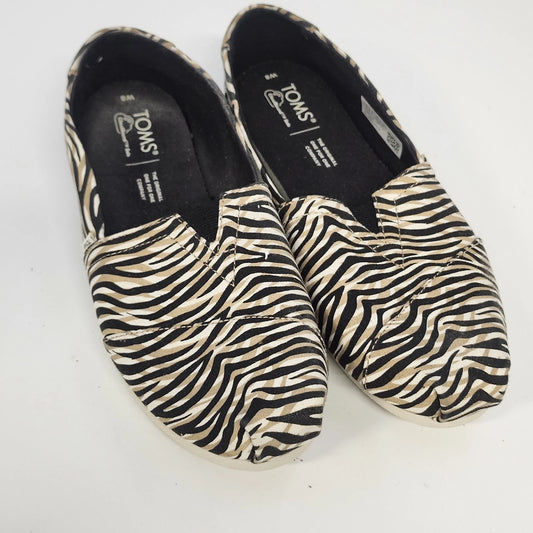 TOMS women's black and cream zebra-print Alpargata slip-on flats with textile uppers and rubber soles.
