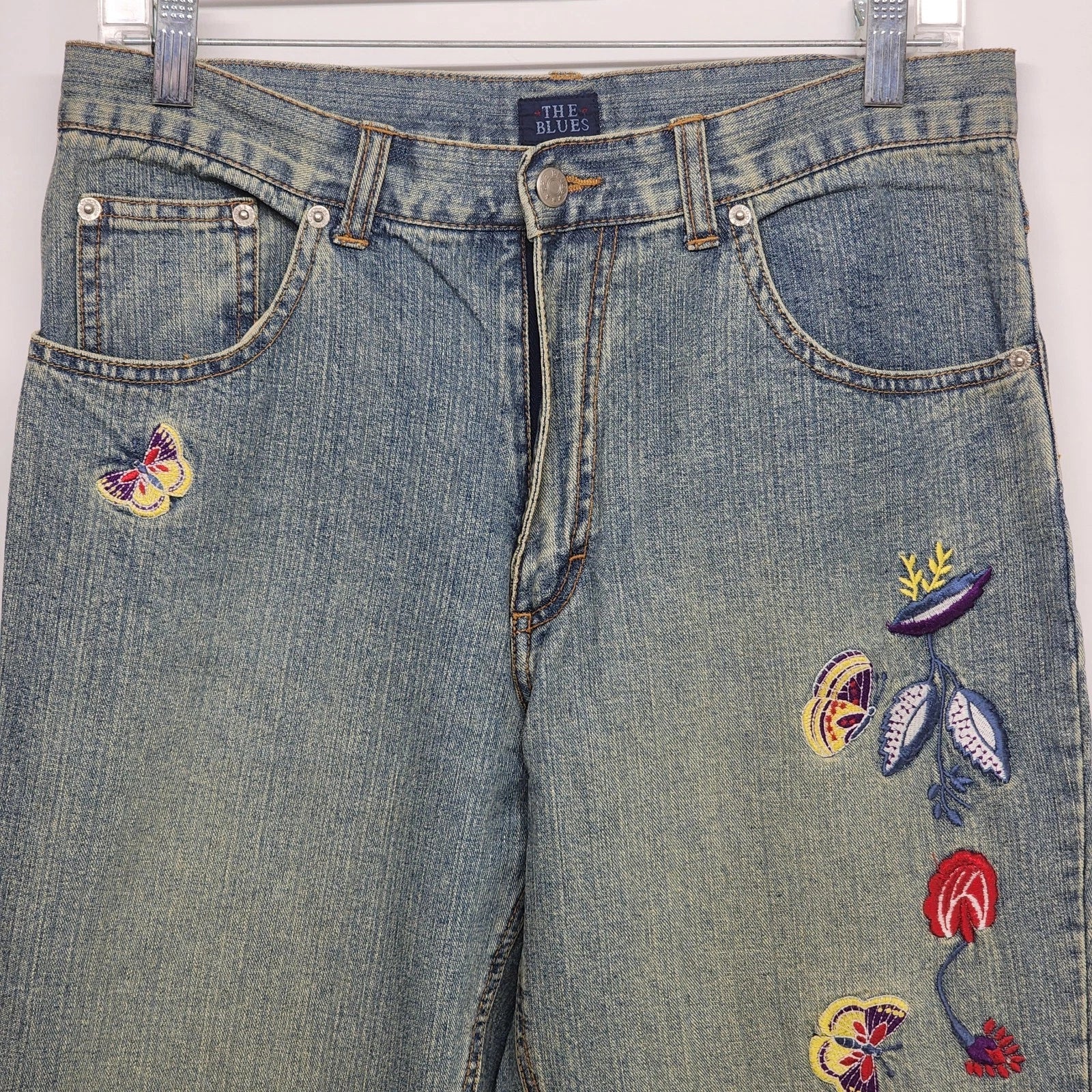 Blue denim jeans with butterfly and flower embroidery