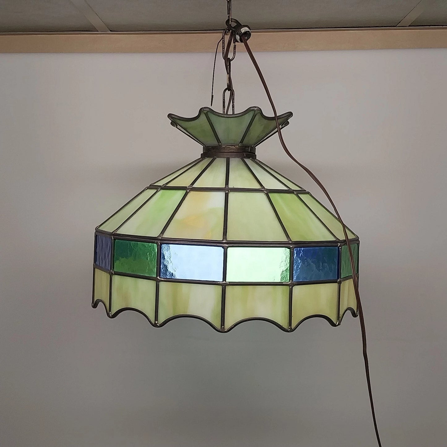 Green Tiffany style stained glass hanging light with white globe diffuser
