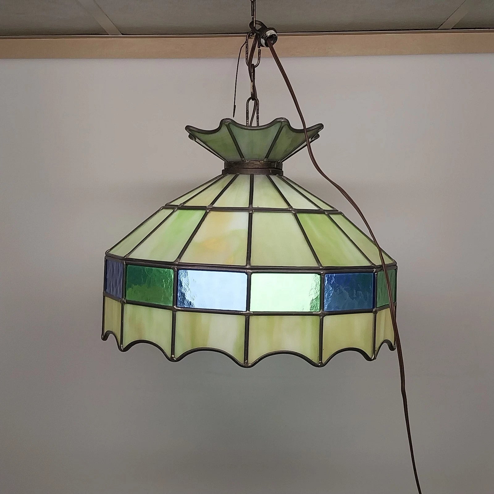 Green Tiffany style stained glass hanging light with white globe diffuser