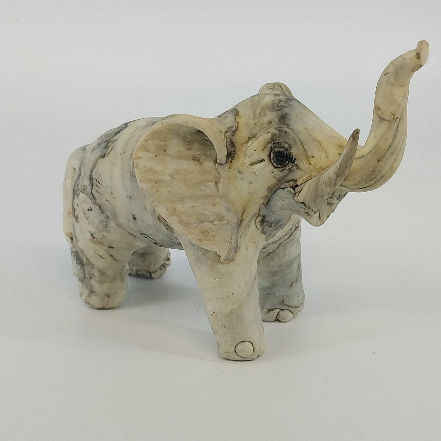 Gray trunk up lucky elephant figurine sculpture
