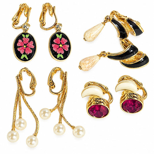 Four pairs of vintage gold-tone clip-on dangle earrings with floral, enamel, crystal-style, and faux pearl designs, including one signed Swarovski pair.
