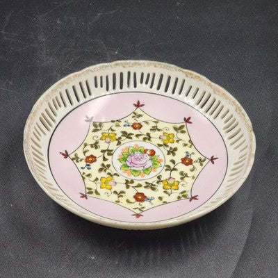 Vintage Asian porcelain bowl with pastel floral painting, lace-cut rim, and gold trim.