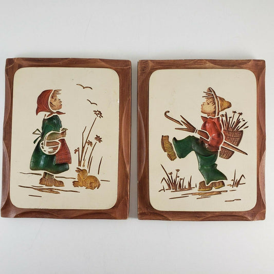 Vintage boy and girl chalk ware wall plaques from 1966