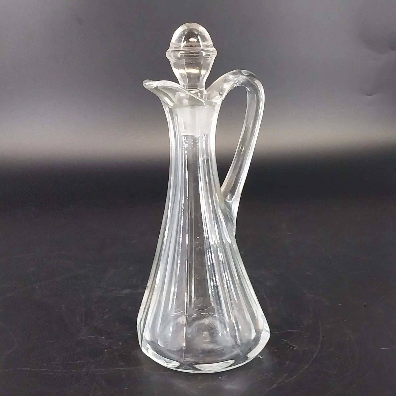 Vintage clear glass cruet bottle with ribbed panels and glass stopper