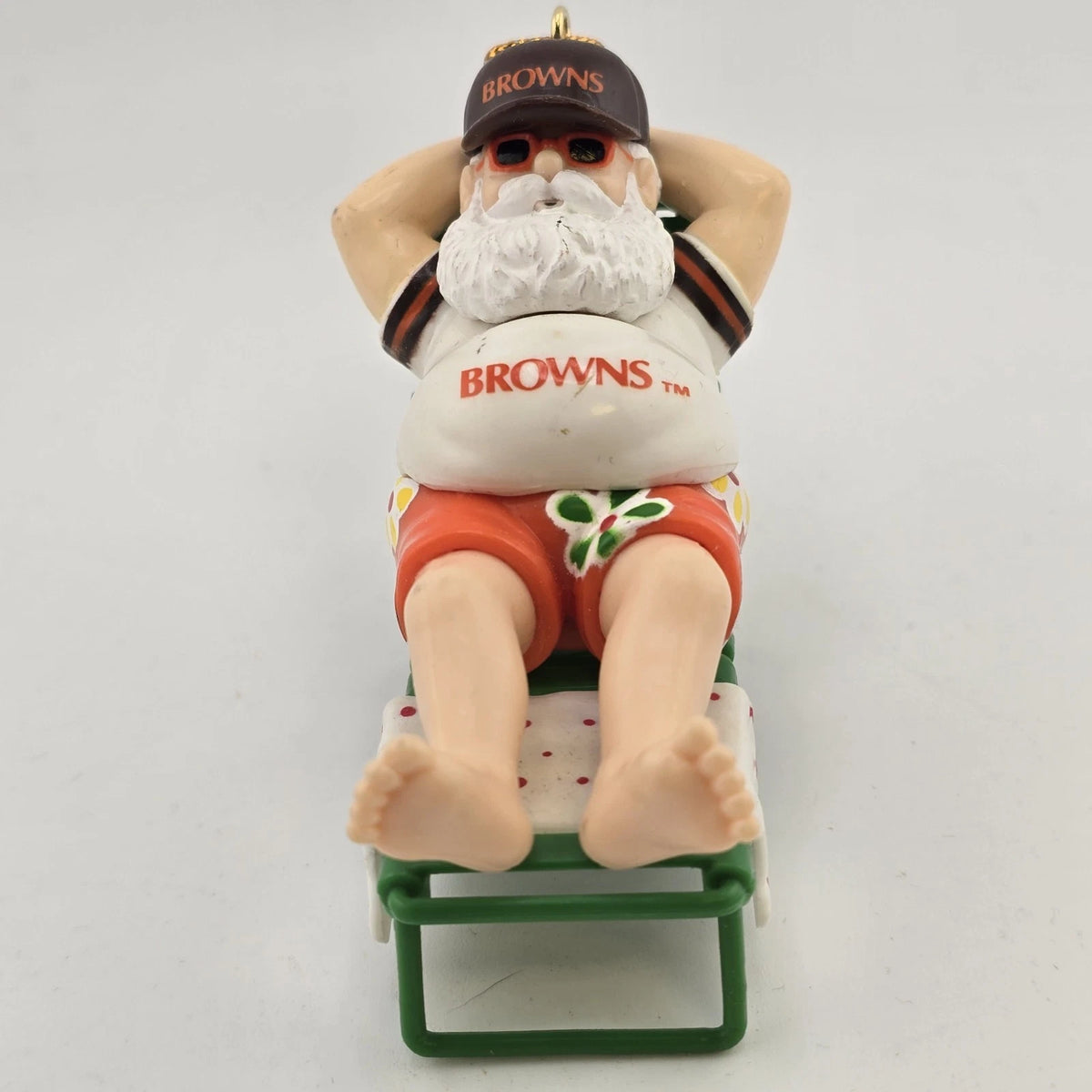Cleveland Browns Santa Claus Christmas ornament sitting on a beach chair