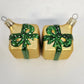 Pair of vintage Czech Republic mouth-blown glass Christmas ornaments shaped like gold gift boxes with green and white polka-dot ribbons, dimensional bows, and original metal hanging caps.