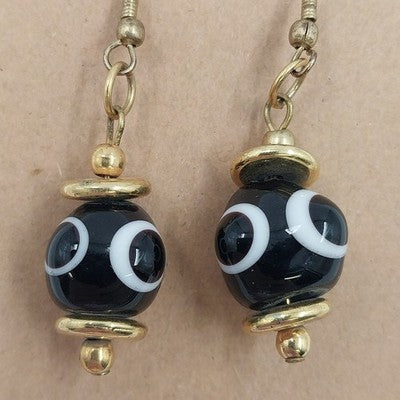 Gold tone black and white round drop dangle earrings with hoop closure