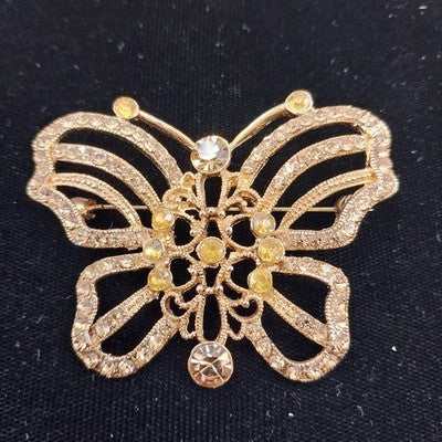 Vintage gold tone butterfly brooch with clear and amber rhinestones