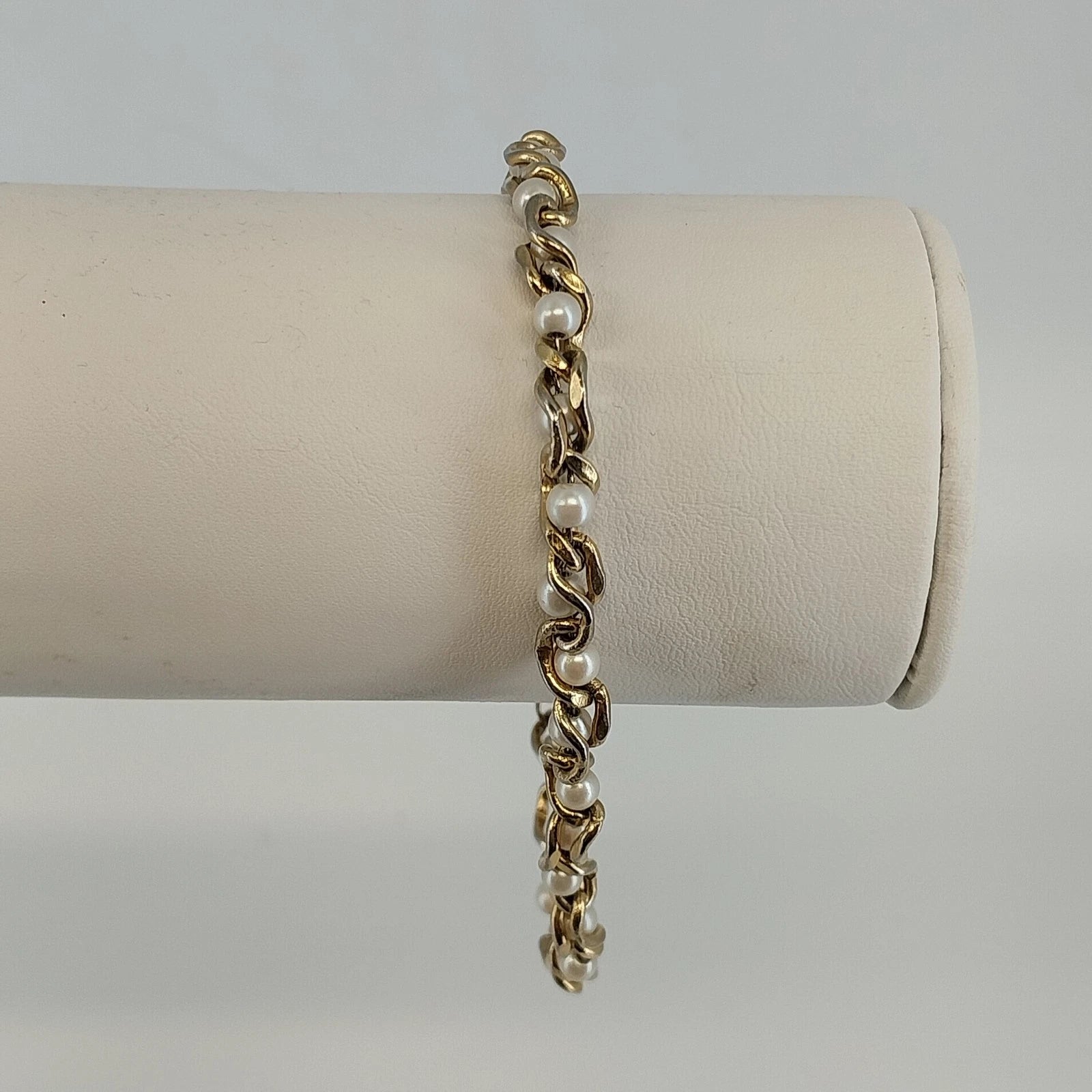 Vintage gold tone link bracelet with faux pearl accents and twist bar links
