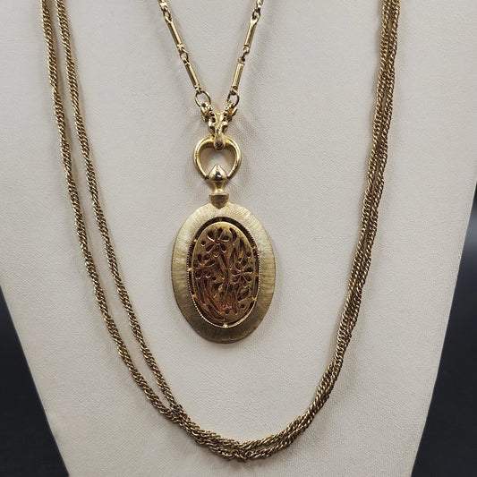 Vintage gold-tone multi-strand necklace with large oval openwork floral filigree pendant