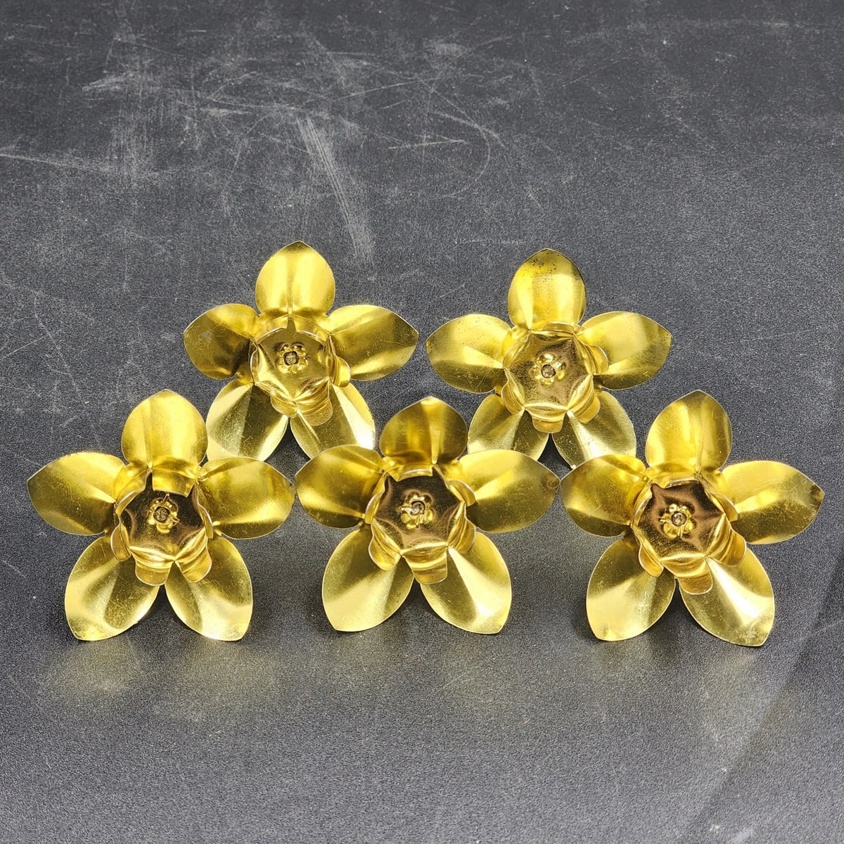 Five vintage hammered brass candle holders with spikes