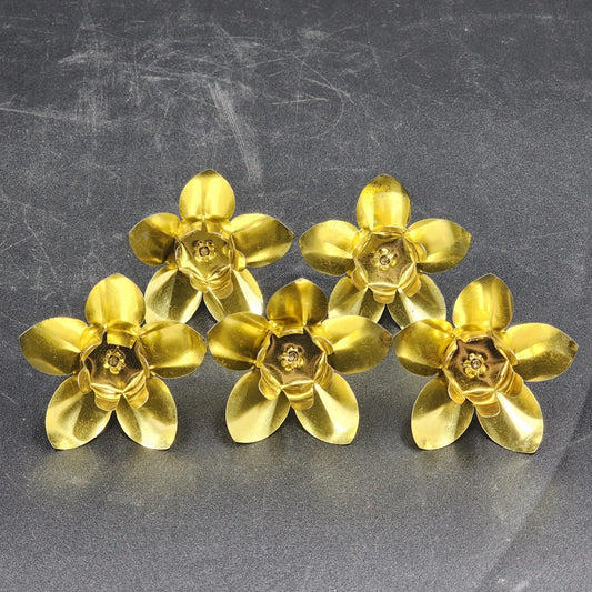 Five vintage hammered brass candle holders with spikes