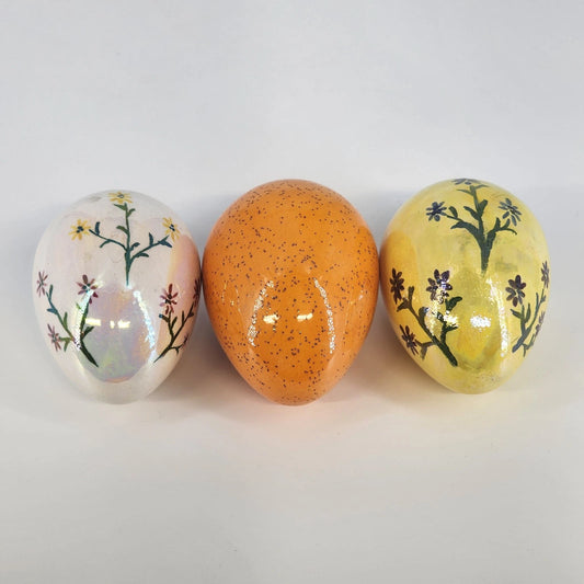 Set of three vintage hand painted ceramic Easter eggs with floral designs