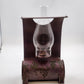 Vintage burgundy metal oil lamp with grapevine design and glass chimney