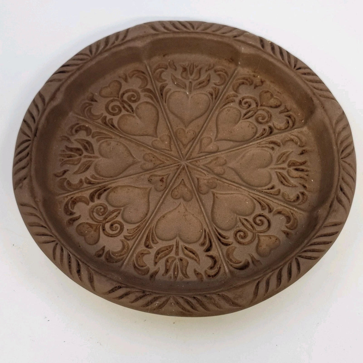 Round brown Hartstone stoneware cookie mold with hearts and tulips.