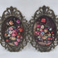 Pair of oval floral prints with ornate gold frames and convex glass