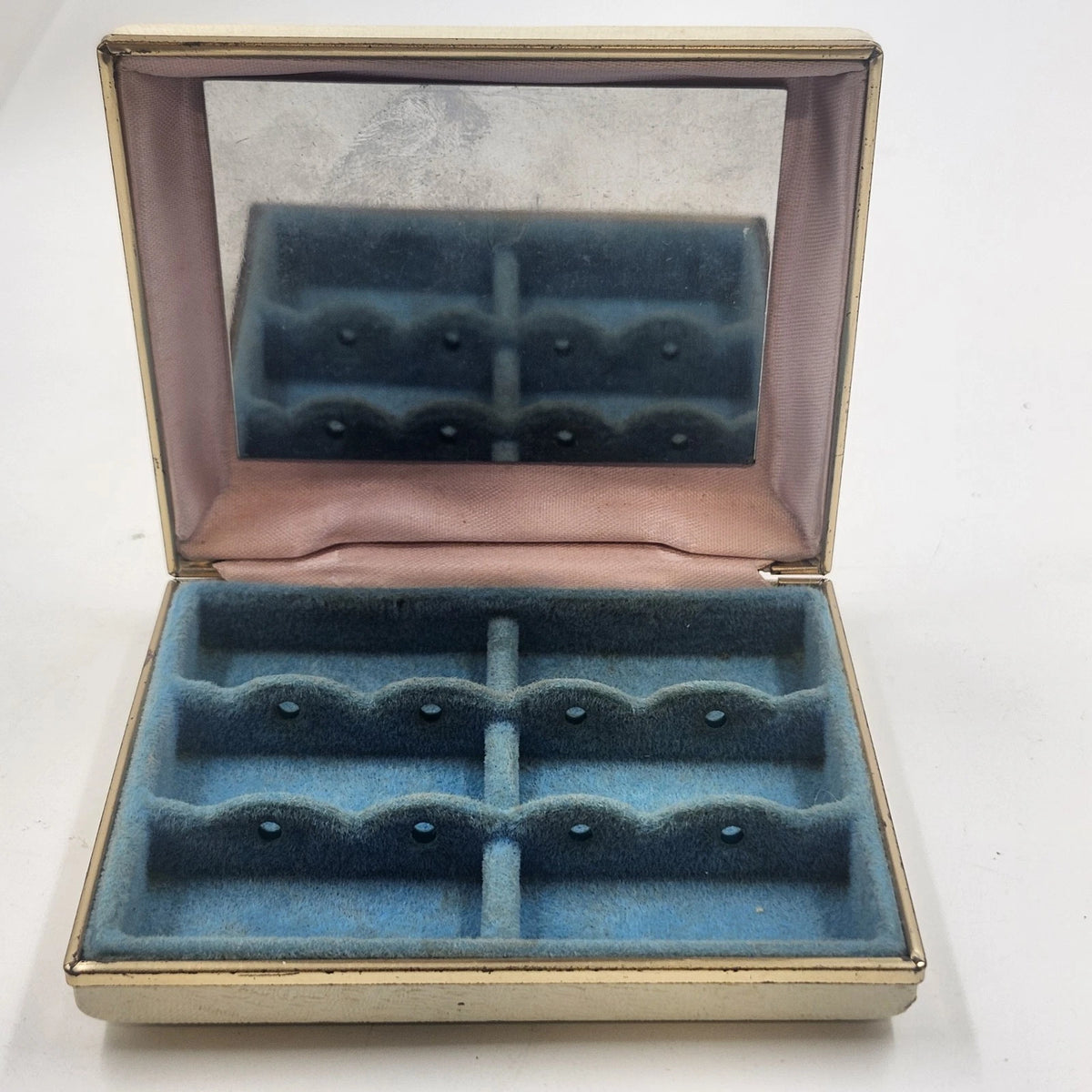 Vintage square ivory jewelry case with gold-tone trim, hinged mirror lid, and blue velvet divided interior for rings and earrings.
