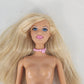 Vintage Mattel Barbie doll with blonde hair and pink necklace