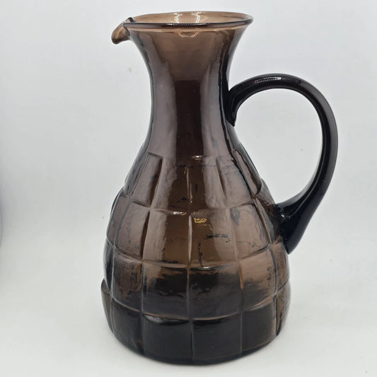 Vintage Morgantown Crinkle pitcher in smoke gray-brown glass with textured geometric pattern and curved handle.