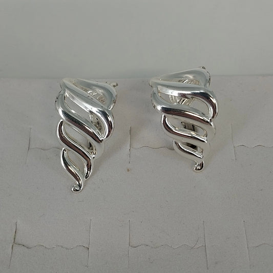Vintage Napier silver tone clip on half hoop earrings with openwork swirl design