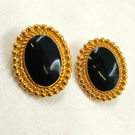 Oval gold tone clip-on earrings with black center stones