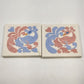 Pair of vintage hand-painted ceramic peacock art tile trivets in pink and blue