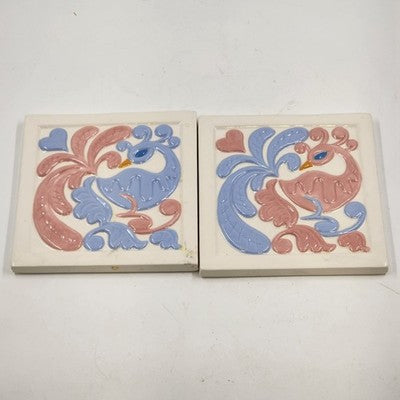 Pair of vintage hand-painted ceramic peacock art tile trivets in pink and blue