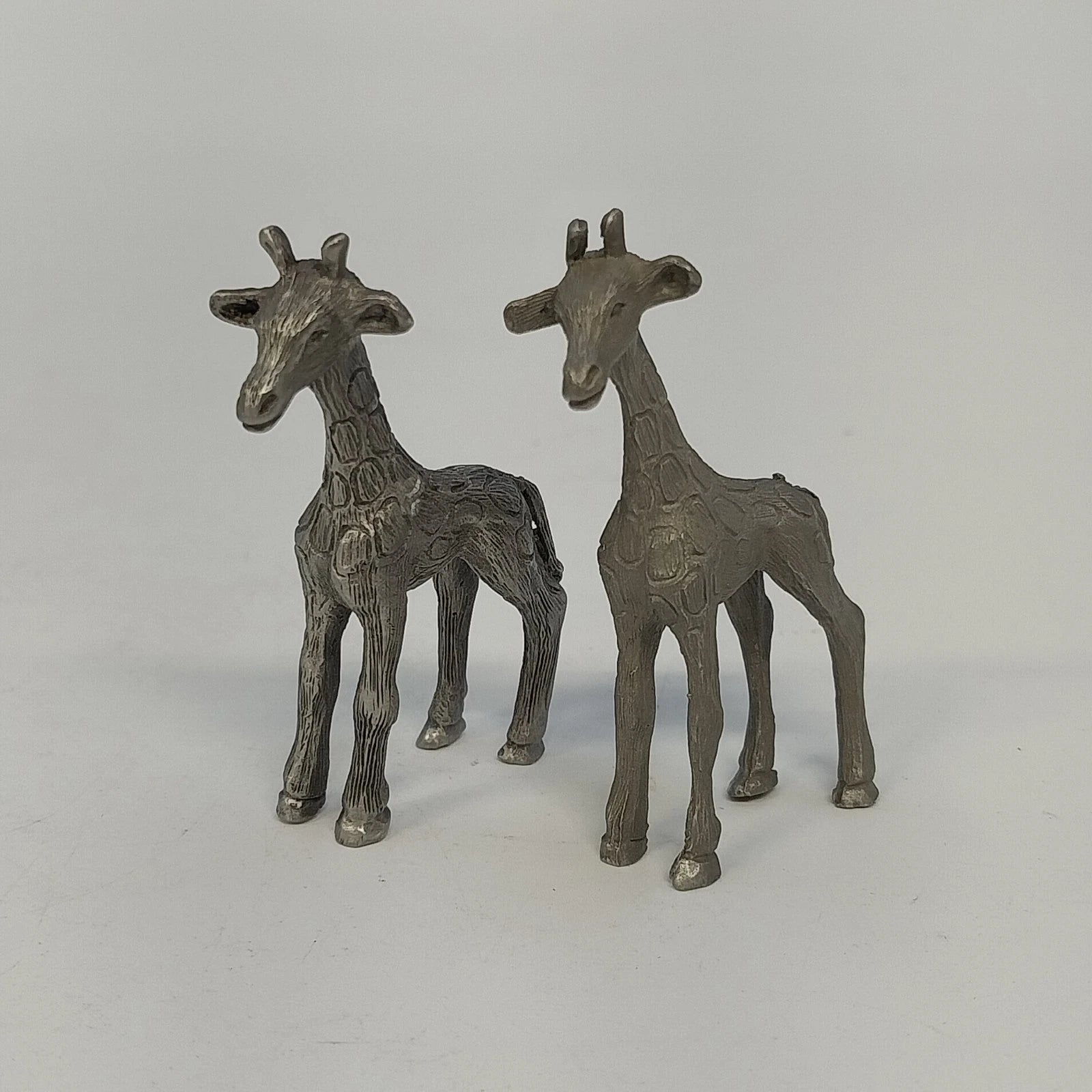 Pair of vintage pewter giraffe miniature figurines