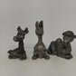 Three vintage pewter giraffe kangaroo and monkey figurines