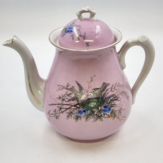 Vintage pink porcelain teapot with bird nest and blue floral design